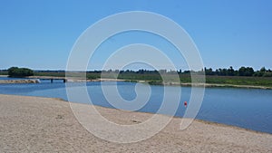 The tagus river and a red steel bridge, Coruche, Portugal