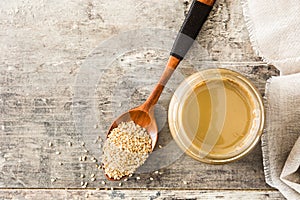 Tahini and sesame seeds on wood