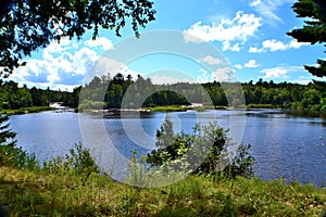 The Tahquamenon River with waterfalls feeding the large body of water