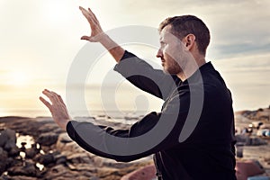 Tai chi, fitness and martial arts with man at beach for exercise and karate, self defense and zen with peace outdoor