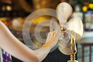 Worshipper at Che Kung Temple, Tai Wai, spinning a brass wheel o