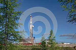 Taiga landscape with a drilling rig in an oil and gas field