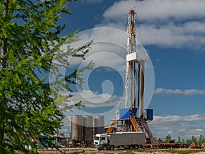 Taiga landscape with a drilling rig in an oil and gas field