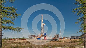 Taiga landscape with a drilling rig in an oil and gas field