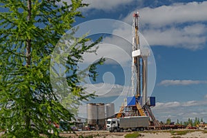 Taiga landscape with a drilling rig in an oil and gas field