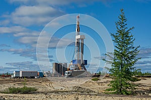 Taiga landscape with a drilling rig in an oil and gas field