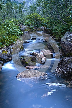 Taiga. Siberia. Mountain stream. Parking near Parabola. Photograph with long shutter speed.