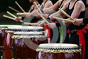 Taiko drummers drumming on Japanese Drums