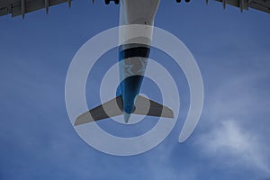 tail of an airplane in a blue sky close up