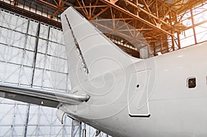 The tail of the airplanein the hangar, the concept repair aircraft maintenance.