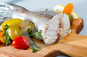 Tail of hake by rustically frying and served with boiled potatoes and tomatoes