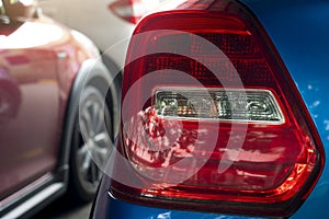 Tail light of a blue car with a red color.