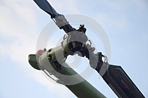 Tail rotor of armoured military helicopter close up against blue sky background