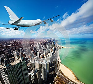 Tail view of jet airplane mid air in Chicago city