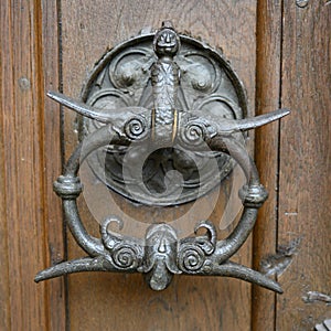 Doorknocker on wooden door with iron sculpture of tailer from Ulm on Ulm Minster, Ulm Cathedral, Baden-Wuerttemberg, Germany photo