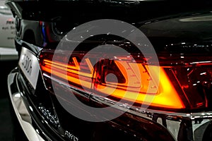 Taillight, headlight of modern prestigious luxurious car. Closeup, macro view of LED xenon car`s headlamp, lamp headlight