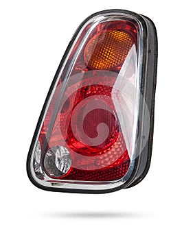 A taillight of a stop signal for a German auto - optical equipment of white and red color on a white isolated background. A spare