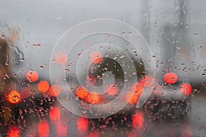 Taillights through a rainy windshield