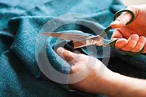 Tailor. Hands notch tailor tailor`s scissors cloth.