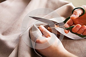 Tailor. Hands notch tailor tailor`s scissors cloth.