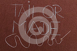 Tailor made text underlined with winding thread in needle