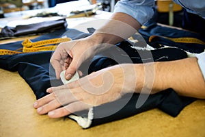 Tailor marking a garment with chalk
