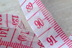 Tailor measuring tape with red numbers.