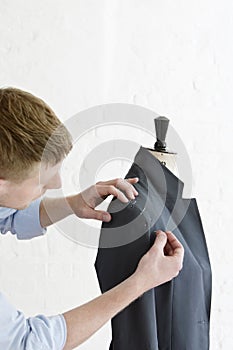 Tailor Pinning Sleeve To Suit On Model In Studio photo