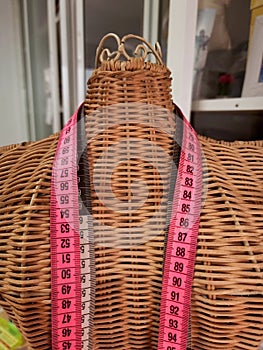 Tailor`s mannequin with measuring tape