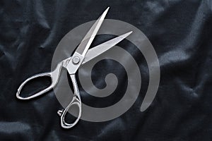 Tailor scissors on black cloth