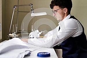 Tailor Sewing Clothes at Machine