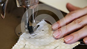 The tailor sews on the old sewing machine.