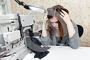 Tailor with strong headache at sewing machine