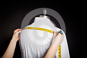 Tailor taking measurements