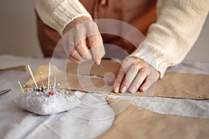 tailor woman using needle thread sew. High quality photo