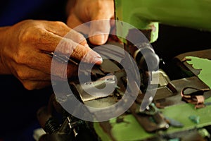 Tailor working on a cutting machine at textile factory