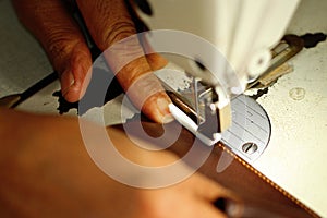 Tailor working on a sewing machine at textile factory