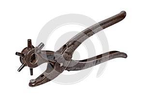 Tailoring accessories. Closeup of a antique adjustable Steel punch pliers or hole punch tool isolated. Clipping path. Tools from