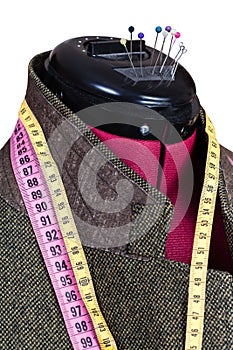 Tailoring of male woolen tweed jacket on dummy