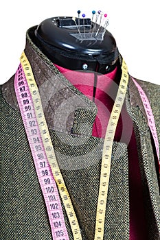 Tailoring of man tweed jacket on mannequin
