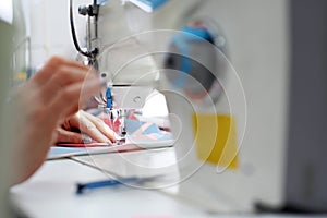 Tailoring. Sewing room, seamstress sews clothes on a sewing machine