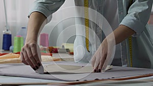 Tailoring woman marking the cloth patterns with soap, atelier service startup