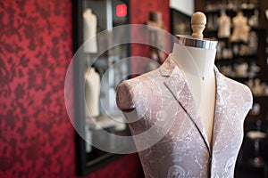 tailors chalk marking fabric on mannequin