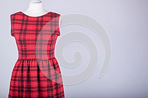 Tailors Mannequin dressed in a Red Tartan Dress