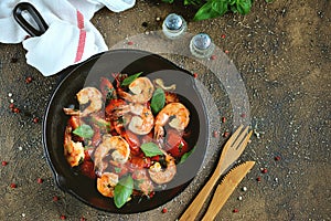 Tails Shrimp fried in olive oil with cherry tomatoes, garlic, thyme, basil, white wine and chili.