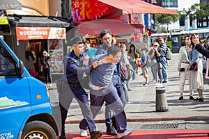 Taipei-Taiwan - DECEMBER 17TH, 2019. Man being handcuffed by police officer at ximen station exit 6, Taiwan