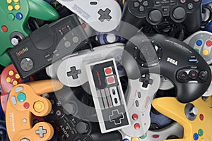 Stack of Retro Video Game Controllers