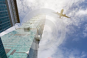 Airplane flying over highrise modern office buildings taipei 101 at taiwan