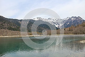 Taisho-ike Pond and snow-capped Mount Hotaka in Kamikochi, Japan