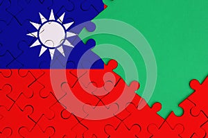 Taiwan flag is depicted on a completed jigsaw puzzle with free green copy space on the right side